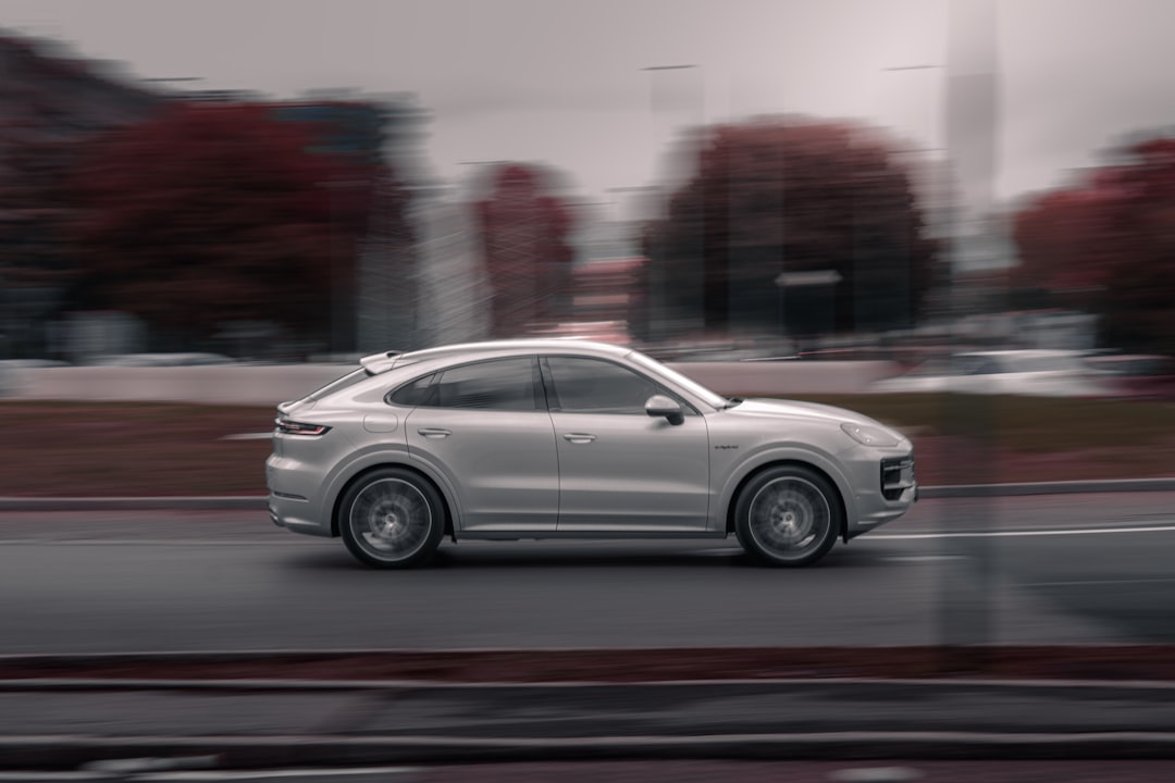 Porsche Cayenne Turbo Coupe elettrica blu in movimento su strada
