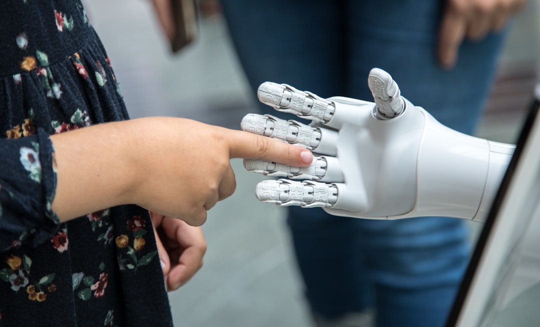 Mano robotica che stringe la mano a una persona, concetto di collaborazione umano-AI in azienda