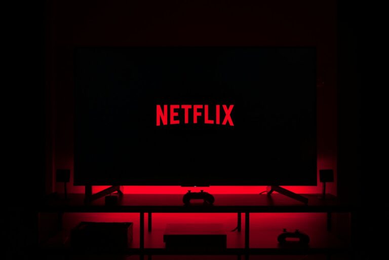Insegna Netflix su edificio moderno, simbolo della strategia di distribuzione esclusivamente digitale